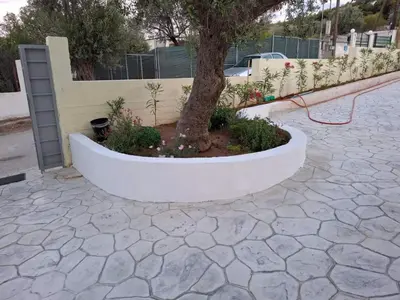a tree in a white planter next to a fence at AIR-IN Rooms with magnificent views in Spáta