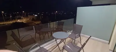 a table and chairs on a balcony at night at AIR-IN Rooms with magnificent views in Spáta