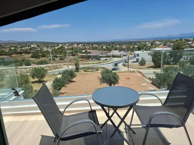a table and chairs on a balcony with a view at AIR-IN Rooms with magnificent views in Spáta