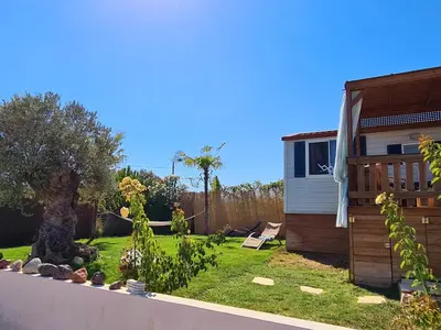 a backyard with a house and a garden at Villa Vravrona Tower & Suites in Markopoulo