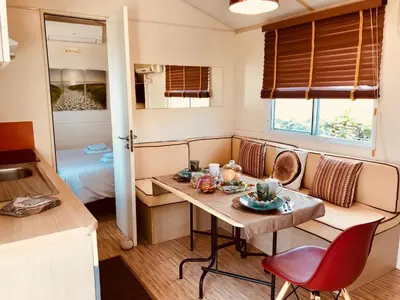 a small room with a table and a bed at Villa Vravrona Tower & Suites in Markopoulo