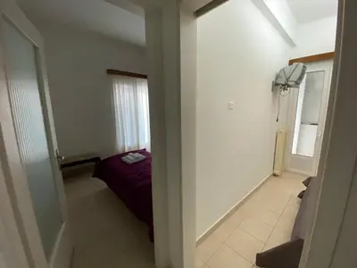 a small room with a bed and a window at Οικογενειακό Διαμέρισμα στην Αθήνα in Athens