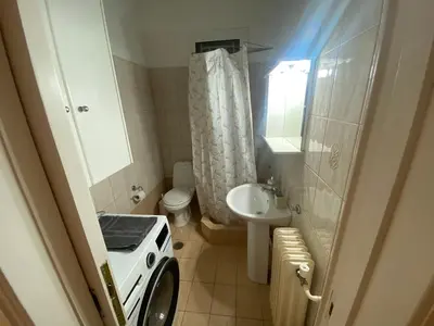 a small bathroom with a washing machine in it at Οικογενειακό Διαμέρισμα στην Αθήνα in Athens