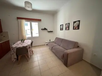 a living room with a couch and a table at Οικογενειακό Διαμέρισμα στην Αθήνα in Athens