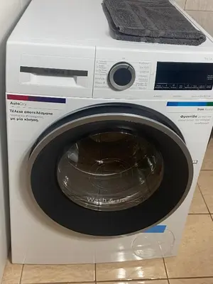 a white washing machine with its door open at Οικογενειακό Διαμέρισμα στην Αθήνα in Athens