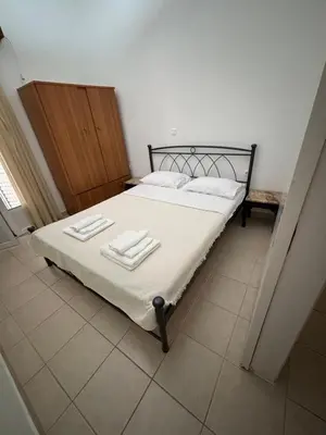 a bedroom with a bed with two towels on it at Οικογενειακό Διαμέρισμα στην Αθήνα in Athens