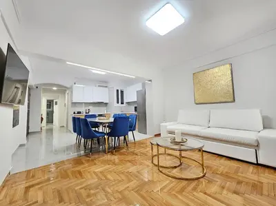 a living room with a white couch and a table at Athens Prestige Suite Apartment in Athens
