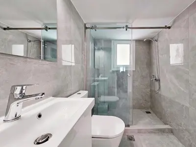 a bathroom with a toilet and a sink and a shower at Athens Prestige Suite Apartment in Athens