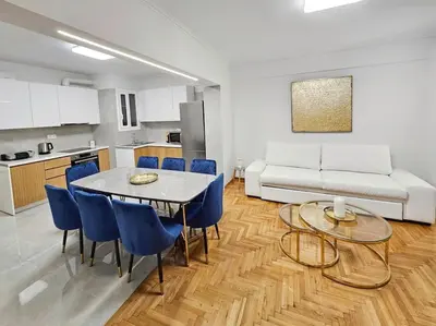 a living room with a table and chairs and a couch at Athens Prestige Suite Apartment in Athens