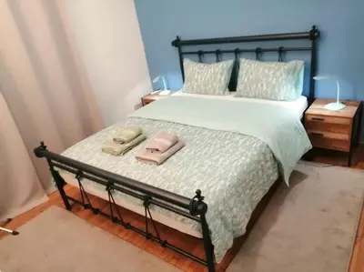 a bedroom with a bed with two towels on it at 8' από Μετρό,Ντυνάν,Παίδων,Λαϊκό in Athens