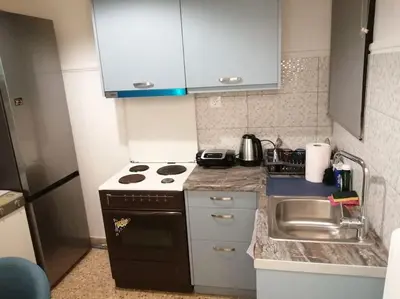 a small kitchen with a stove and a sink at 8' από Μετρό,Ντυνάν,Παίδων,Λαϊκό in Athens