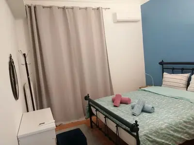a bedroom with a bed with two pillows on it at 8' από Μετρό,Ντυνάν,Παίδων,Λαϊκό in Athens