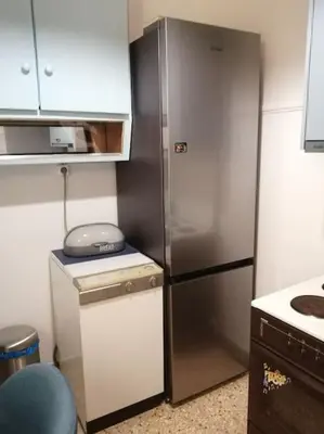 a stainless steel refrigerator in a small kitchen at 8' από Μετρό,Ντυνάν,Παίδων,Λαϊκό in Athens