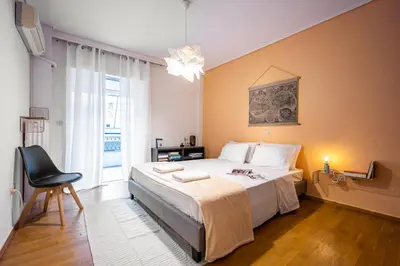 a bedroom with a bed and a chair and a window at Group&Family Luxury in Athens