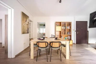 a dining room with a wooden table and chairs at Group&Family Luxury in Athens