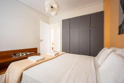 a bedroom with a bed with two towels on it at Group&Family Luxury in Athens