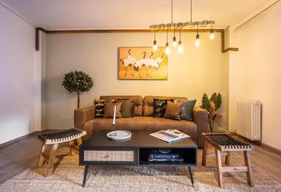 a living room with a couch and a table at Group&Family Luxury in Athens