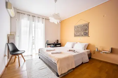 a bedroom with a large bed and a chair at Group&Family Luxury in Athens
