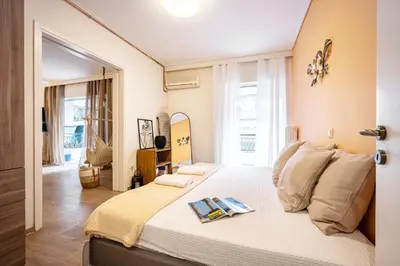 a bedroom with a bed with two magazines on it at Group&Family Luxury in Athens
