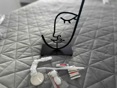 a toothbrush and toothpaste on top of a bed at Cozy apartment in a new building apartment 5 in Piraeus