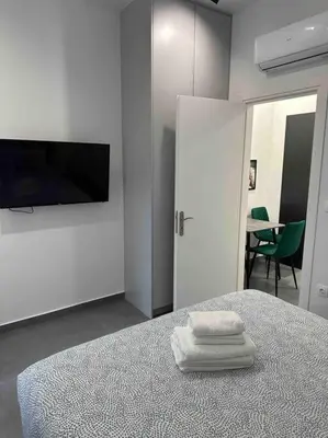 a bedroom with a bed with two white towels on it at Cozy apartment in a new building apartment 5 in Piraeus