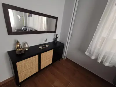 a bathroom with a black vanity and a mirror at Athens Oasis Apartment in Athens