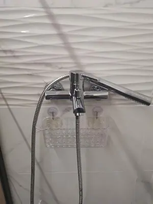 a shower head in a bathroom with some bubbles at Athens Oasis Apartment in Athens