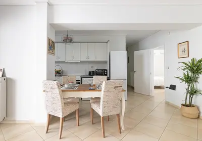 a kitchen and dining room with a table and chairs at Elegant Apt 50meters Close Acropolis in Athens
