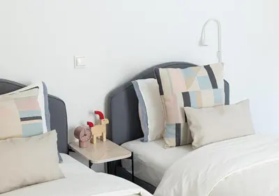 a bedroom with two beds and a couch with pillows at Elegant Apt 50meters Close Acropolis in Athens