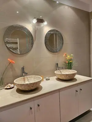 two sinks in a bathroom with two mirrors at Guest apartment within a villa in Lagonissi in Kalívia Thorikoú