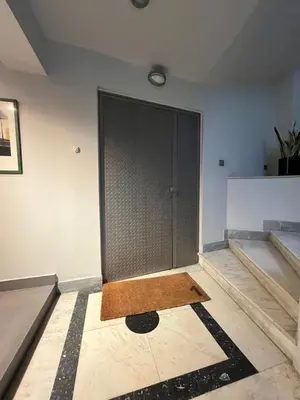 a large door in a room with a floor at Mosaikon Guesthouses #Vasilikis Str in Athens