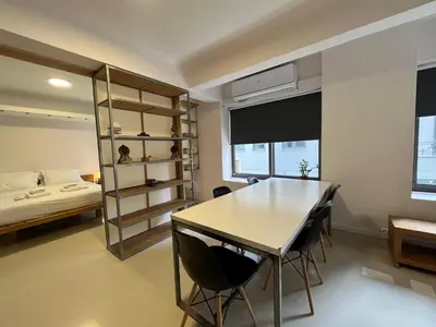 a room with a table and chairs and a bed at Mosaikon Guesthouses #Vasilikis Str in Athens