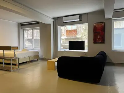 a bedroom with a bed and a couch and a tv at Mosaikon Guesthouses #Vasilikis Str in Athens