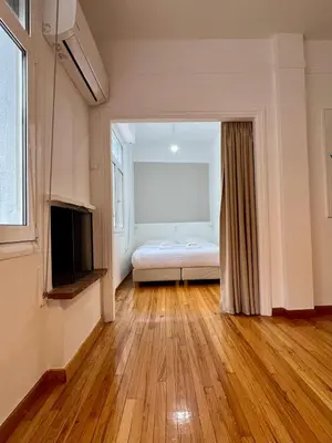 a bedroom with a bed and a television in a room at Mosaikon Guesthouses #Miltiadou Str in Athens