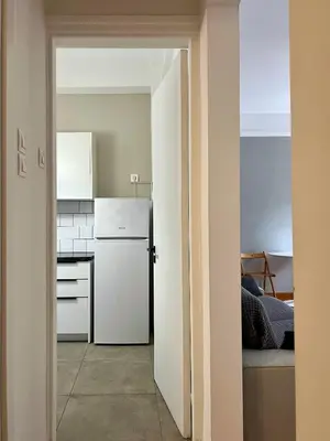 a kitchen with a white refrigerator in a room at Mosaikon Guesthouses #Miltiadou Str in Athens