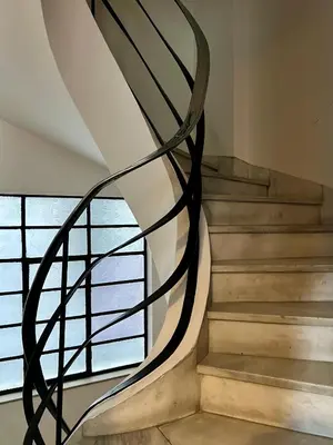 a spiral staircase in a house with a window at Mosaikon Guesthouses #Miltiadou Str in Athens