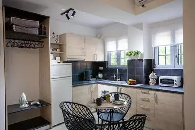 a kitchen with a small table and chairs in it at Ifaistos Luxury flat Psyrri square in Athens