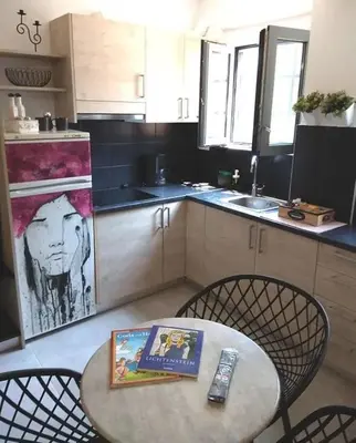 a kitchen with a table with a book on it at Ifaistos Luxury flat Psyrri square in Athens