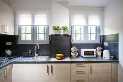 a kitchen with a sink and a microwave at Ifaistos Luxury flat Psyrri square in Athens