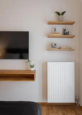 a living room with a tv and a radiator at Acropolis Vibe Residence in Athens