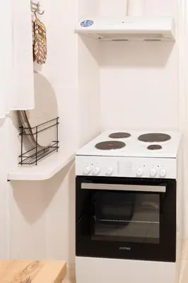 a black and white stove in a white kitchen at Agora Apartment Plaka and Acropolis area in Athens