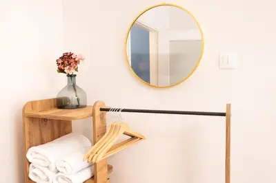 a bathroom with a mirror and a shelf with towels at Agora Apartment Plaka and Acropolis area in Athens