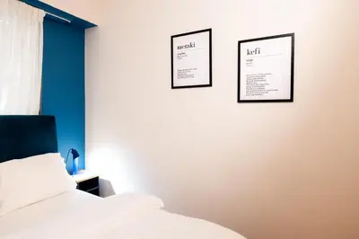 a bedroom with two pictures on the wall and a bed at Agora Apartment Plaka and Acropolis area in Athens