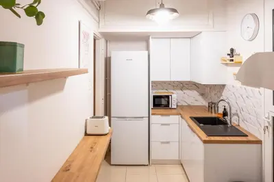 a kitchen with white cabinets and a refrigerator at Agora Apartment Plaka and Acropolis area in Athens