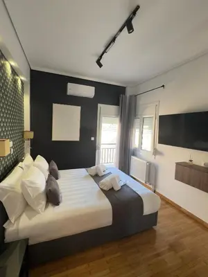 a bedroom with a large bed with two teddy bears on it at Acropolis Golden View Penthouse in Athens