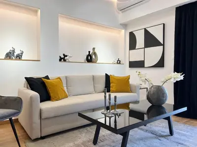 a living room with a couch and a table at Acropolis Golden View Penthouse in Athens