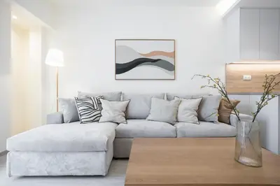 a living room with a couch and a table at Deluxe Apartment in Kallithea with Balcony & Wifi in Athens