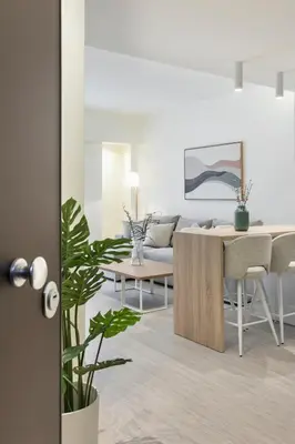 a living room with a table and a dining room at Deluxe Apartment in Kallithea with Balcony & Wifi in Athens