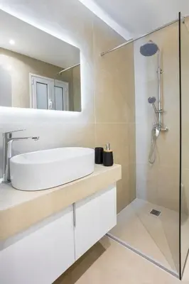 a bathroom with a sink and a mirror at Deluxe Apartment in Kallithea with Balcony & Wifi in Athens