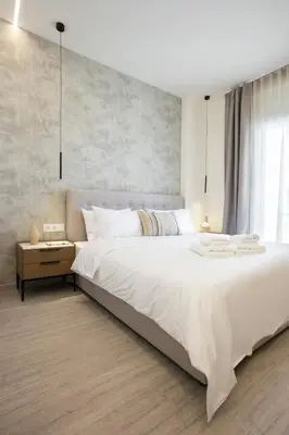 a bedroom with a large white bed and a window at Deluxe Apartment in Kallithea with Balcony & Wifi in Athens